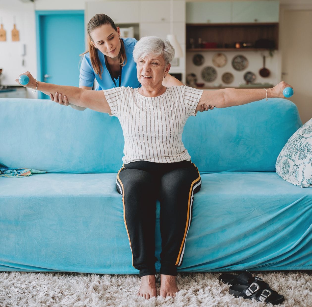 A physio assisting an elderly lady